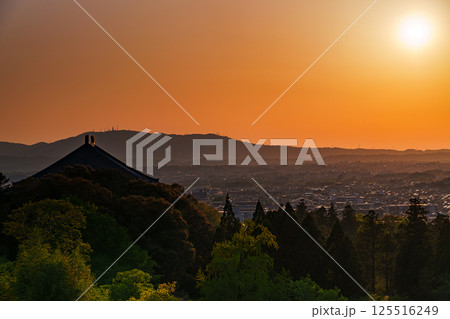 東大寺二月堂の夕焼け空　空と境内を黄金色に染めながら生駒の山並みに沈んで行く夕日⑩ 125516249