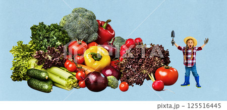 Little girl, child in hat and shovel, standing amazed by giant vegetable harvest collection with fresh greens on blue background. 125516445