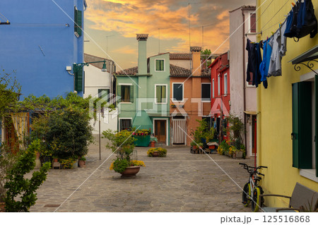 Charming colorful houses with sunset sky on Burano island Italy 125516868
