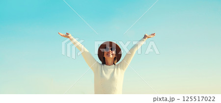 Happy smiling traveler woman on sunny beach, joyful girl enjoying on sea coast background 125517022