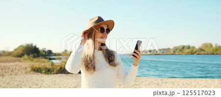 Travel, adventure, traveler woman taking selfie with phone on beach, girl using smartphone on coast 125517023
