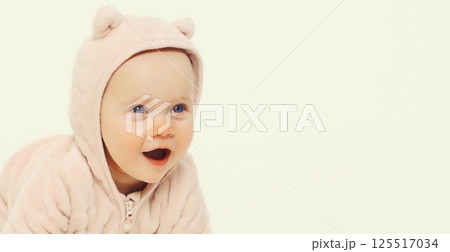 Happy cute baby crawling on the floor on white studio background 125517034