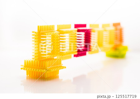 A children's construction set with bright parts looks attractive and inspires play. The elements of the play-constructor are made from safe materials. A children's construction set with bright parts looks attractive and inspires play. The elements of the play-constructor are made from safe materials. 125517719