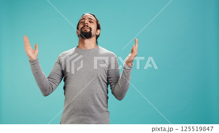 Cheerful pious man looking up to sky, waiting for sign from his god. Happy spiritual man doing worship hand gesturing, waiting for miracle, isolated over studio background, camera B Cheerful pious man looking up to sky, waiting for sign from his god. Happy spiritual man doing worship hand gesturing, waiting for miracle, isolated over studio background, camera B 125519847