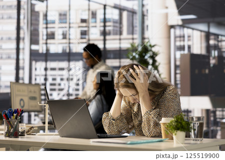 Stressed businesswoman faces a migraine from corporate pressure, feeling overworked and frustrated. Woman feeling overwhelmed by deadlines and struggles with burnout, emotional strain. Stressed businesswoman faces a migraine from corporate pressure, feeling overworked and frustrated. Woman feeling overwhelmed by deadlines and struggles with burnout, emotional strain. 125519900