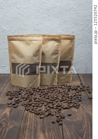 Freshly ground coffee beans on wooden table, perfect for coffee lovers. copyspace. 125520742