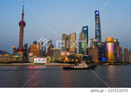 Shanghai, China - 1 April 2025: Editorial night skyline view of Pudong district at sunset across the Huangpu River, featuring the Oriental Pearl Tower and financial center Shanghai, China - 1 April 2025: Editorial night skyline view of Pudong district at sunset across the Huangpu River, featuring the Oriental Pearl Tower and financial center 125521070