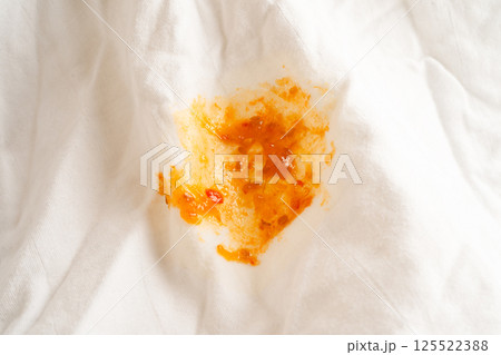 Dirty tomato sauce stain or ketchup on cloth to wash with washing powder, cleaning housework. Dirty tomato sauce stain or ketchup on cloth to wash with washing powder, cleaning housework. 125522388