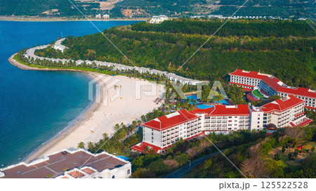 Luxury seaside hotel at sea with sandy beach in island in tropics, top aerial view. A resort in Asia Luxury seaside hotel at sea with sandy beach in island in tropics, top aerial view. A resort in Asia 125522528