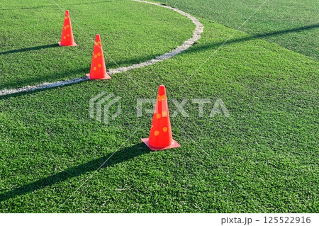 artificial green grass soccer field with orange training cones artificial green grass soccer field with orange training cones 125522916