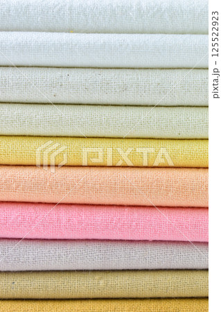 stack of colourful cotton clothes, close up pile of clothing stack of colourful cotton clothes, close up pile of clothing 125522923