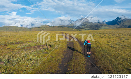 Aerial view of woman trail runner in high altitude mountains 125523187