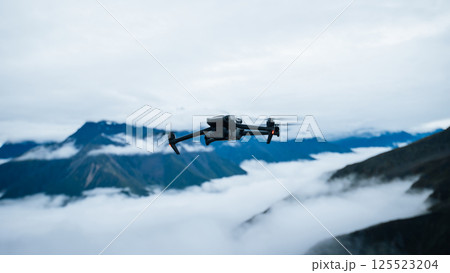 Drone flying on high altitude mountain top Drone flying on high altitude mountain top 125523204