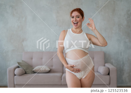 Happy Pregnant Woman Recommends Adult Diapers. Happy Pregnant Woman Recommends Adult Diapers. 125523536