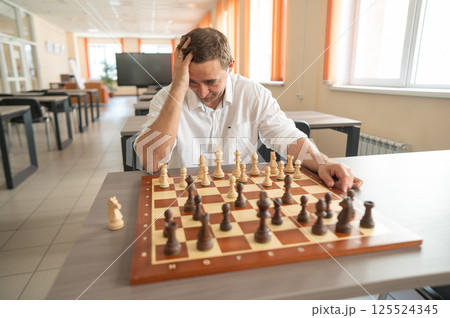 Portrait Caucasian man playing chess.  125524345