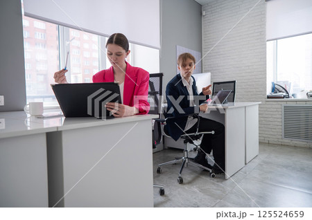 Caucasian young man spying on colleague. Caucasian young man spying on colleague. 125524659