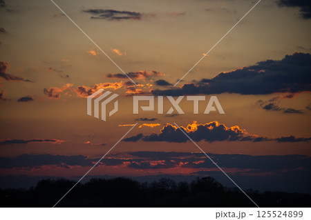 The sky bursts into a symphony of colors during a breathtaking sunset. The sky bursts into a symphony of colors during a breathtaking sunset. 125524899