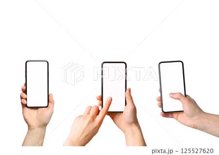 Hands showcase three smartphones with blank displays for use, isolated on white 125527620
