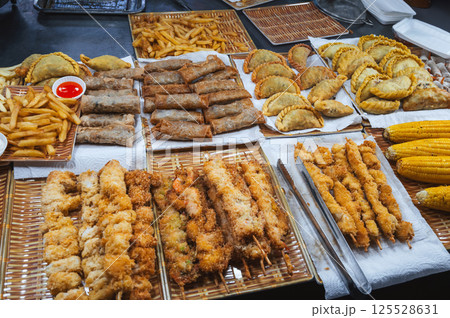 Traditional Vietnamese food and pastries on counter at Asian night market on the street in Vietnam in Asia Traditional Vietnamese food and pastries on counter at Asian night market on the street in Vietnam in Asia 125528631