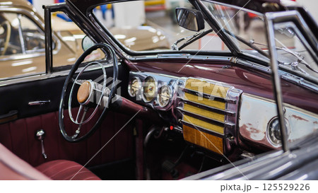 Interior view of vintage convertible car showing steering wheel and dashboard 125529226