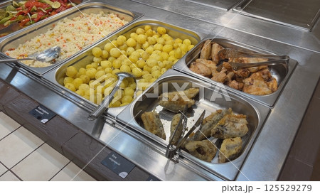 Self-service restaurant offering various dishes including potatoes, rice, chicken and fish Self-service restaurant offering various dishes including potatoes, rice, chicken and fish 125529279