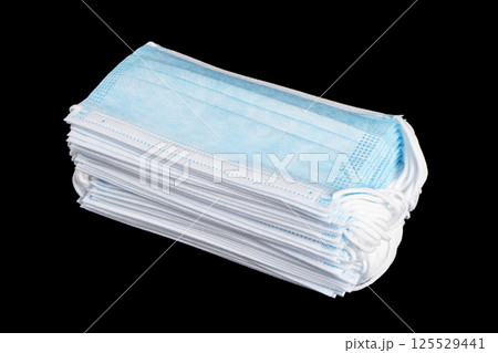 Heap of medical mask. Protective masks isolated on black background. Healthcare and medical concept. Protective face mask or medical mask. Medical protective shielding bandage 125529441
