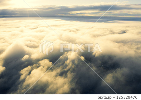Aerial view white clouds in blue sky. View from drone. Aerial view cloudscape texture background. Texture of clouds. View from above. Panorama clouds background 125529470