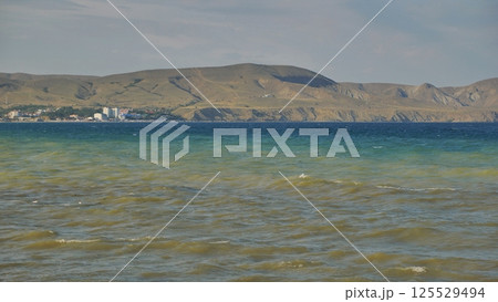 Koktebel bay embracing the Crimean coast with turquoise and brown shades of water Koktebel bay embracing the Crimean coast with turquoise and brown shades of water 125529494