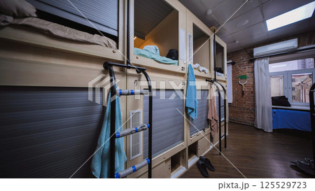Capsule hotel room showing individual sleeping boxes offering privacy and convenience Capsule hotel room showing individual sleeping boxes offering privacy and convenience 125529723