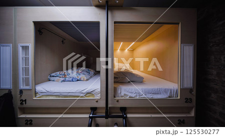 Empty capsule hotel room inviting guests for comfortable rest Empty capsule hotel room inviting guests for comfortable rest 125530277