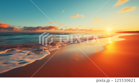 Closeup of a tranquil sea shore with golden sand at sunset under colorful sky with soft clouds and gentle waves in panoramic view 125530621