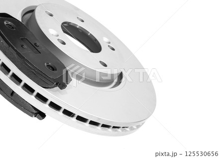 Brake discs and brake pads isolated on white background. Auto parts. Brake disc rotor isolated on white. Braking disk. Car part. Car detailing. Black and white 125530656