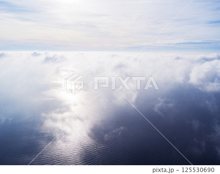 Aerial view White clouds in blue sky. Top view. View from drone. Aerial bird's eye view. Aerial top view cloudscape. Texture of clouds. View from above. Sunrise over the sea Aerial view White clouds in blue sky. Top view. View from drone. Aerial bird's eye view. Aerial top view cloudscape. Texture of clouds. View from above. Sunrise over the sea 125530690