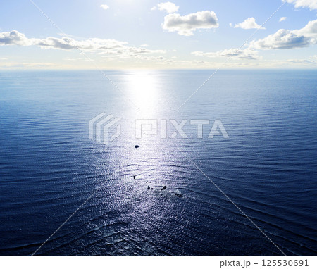 Aerial view of a Sunrise sky background. Aerial Dramatic gold sunrise sky with morning sky clouds over the sea. Stunning sky clouds in the sunrise. Sky landscape. Aerial photography. Aerial view of a Sunrise sky background. Aerial Dramatic gold sunrise sky with morning sky clouds over the sea. Stunning sky clouds in the sunrise. Sky landscape. Aerial photography. 125530691