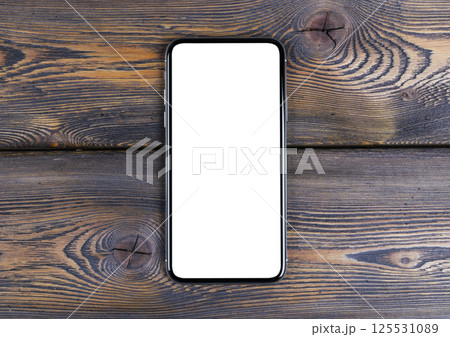 Smartphone with blank screen mock up. Smartphone isolated screen with clipping path. Mobile phone white screen with copy space on office desk. Empty space for text. Isolated white screen Smartphone with blank screen mock up. Smartphone isolated screen with clipping path. Mobile phone white screen with copy space on office desk. Empty space for text. Isolated white screen 125531089