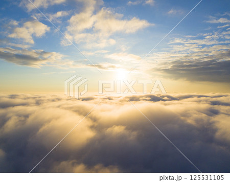 Aerial view White clouds in blue sky. Top view. View from drone. Aerial bird's eye view. Aerial top view cloudscape. Texture of clouds. View from above. Sunrise or sunset over clouds Aerial view White clouds in blue sky. Top view. View from drone. Aerial bird's eye view. Aerial top view cloudscape. Texture of clouds. View from above. Sunrise or sunset over clouds 125531105