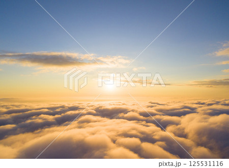 Aerial view White clouds in blue sky. Top view. View from drone. Aerial bird's eye view. Aerial top view cloudscape. Texture of clouds. View from above. Sunrise or sunset over clouds Aerial view White clouds in blue sky. Top view. View from drone. Aerial bird's eye view. Aerial top view cloudscape. Texture of clouds. View from above. Sunrise or sunset over clouds 125531116