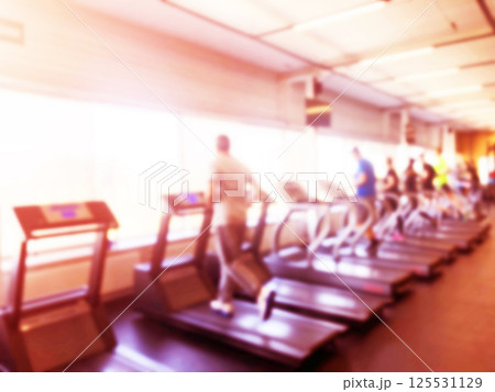 Blurred background with fitness gym people cardio workout in sport club center. Blurred picture of running people. Gym equipment concept. Blurred fitness gym Sport club center 125531129
