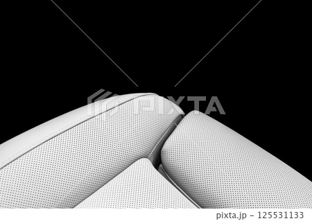 White leather interior of the luxury modern car. Perforated white leather comfortable seats with stitching isolated on black background. Modern car interior details. Car detailing. Car inside 125531133