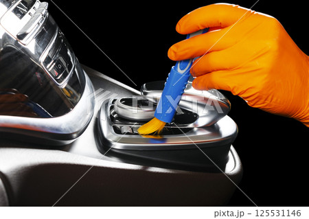 A man cleaning car with brush. Car detailing or valeting concept. Selective focus. Car detailing. Cleaning with sponge. Worker cleaning. Car wash concept solution to clean 125531146