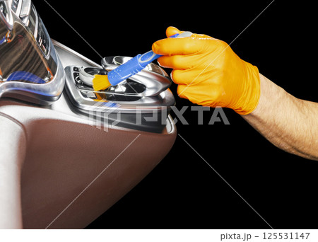 A man cleaning car with brush. Car detailing or valeting concept. Selective focus. Car detailing. Cleaning with sponge. Worker cleaning. Car wash concept solution to clean 125531147