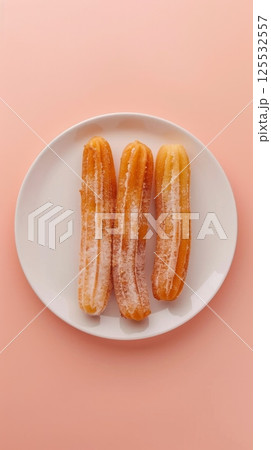 American churros dough sticks sugar flour pastry snack dessert on white plate 125532557