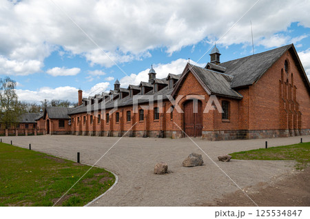 Zagare manor red brick stables on a sunny spring day, Lithuania Zagare manor red brick stables on a sunny spring day, Lithuania 125534847