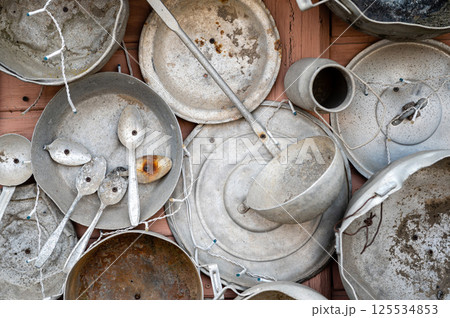 The pan house - puodu namas is covered with pots and pans of all shapes and sizes, closeup view The pan house - puodu namas is covered with pots and pans of all shapes and sizes, closeup view 125534853