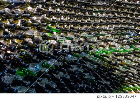 Wine bottles in a row on a stone wall. Close-up 125535047