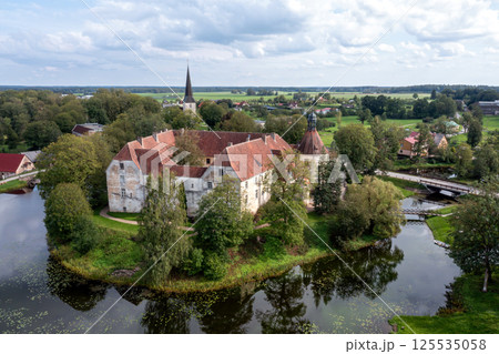 Jaunpils castle was built in 1301. as Livonia Order fortress. Latvia, aerial drone view 125535058