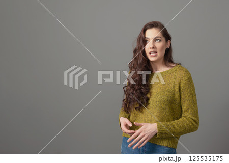 portrait of beautiful sensual woman with long curly hair against gray background portrait of beautiful sensual woman with long curly hair against gray background 125535175