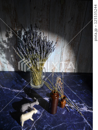 Felt toys of goats and donkeys, stems with lavender flowers in clay vases Felt toys of goats and donkeys, stems with lavender flowers in clay vases 125535244