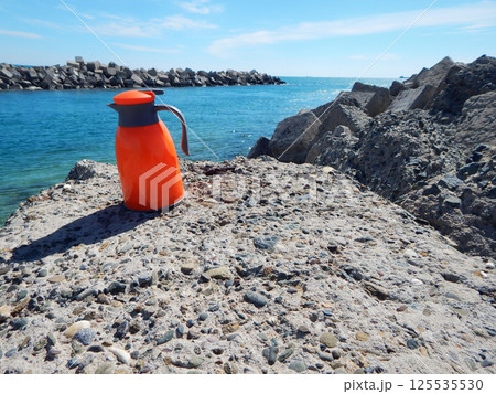 Orange thermos jug. Orange thermos jug. 125535530