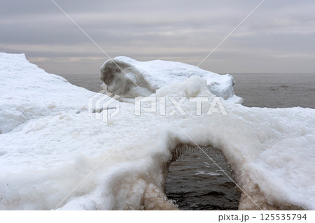 Seascape depicting landscape of Baltic sea and beach with ice and snow formations 125535794